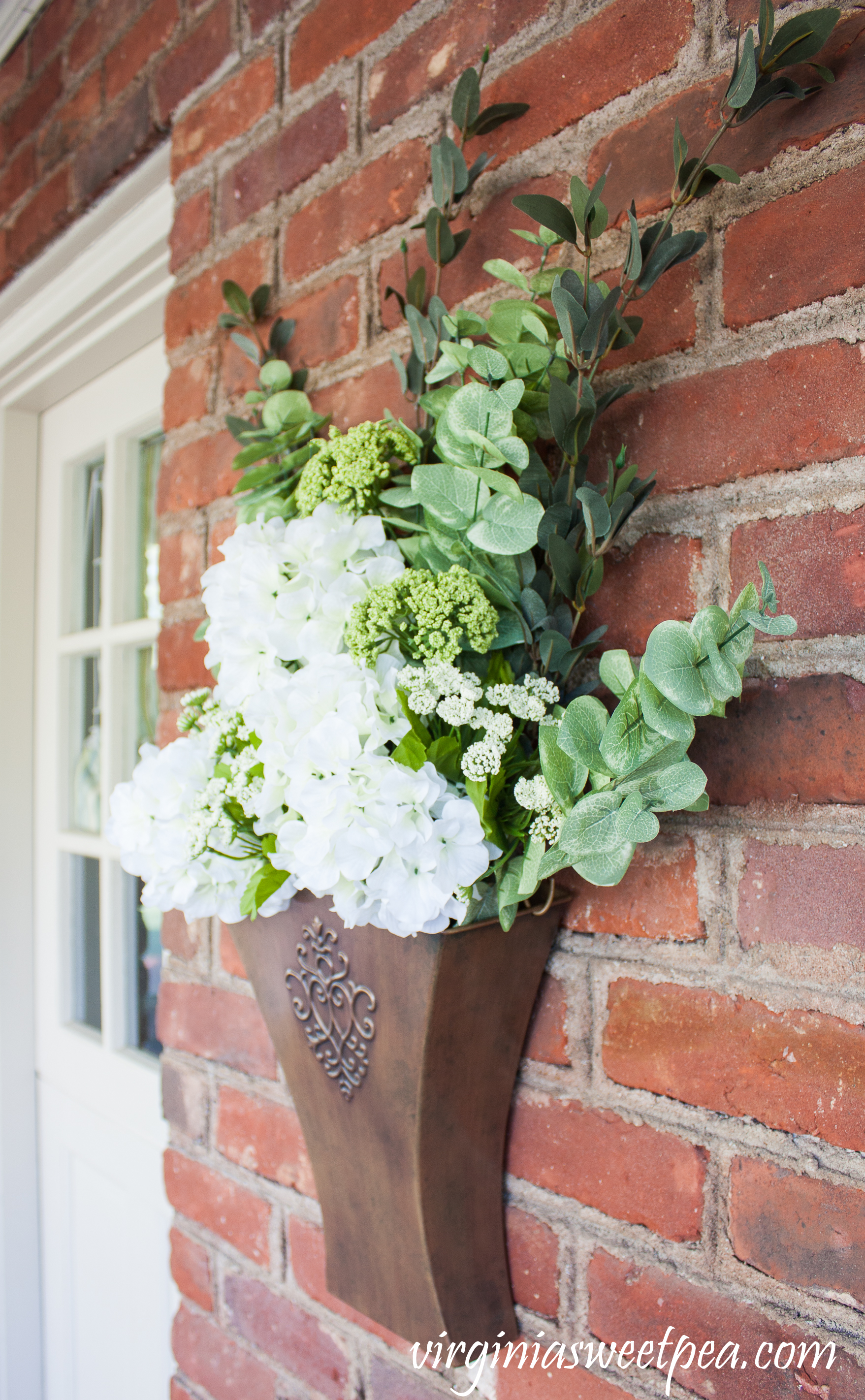 Spring floral arrangement in a Southern Living at Home Willow House Flower Market Door Bucket