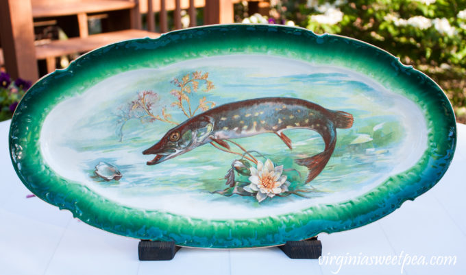 Antique fish platter displayed using a DIY wood display stand.