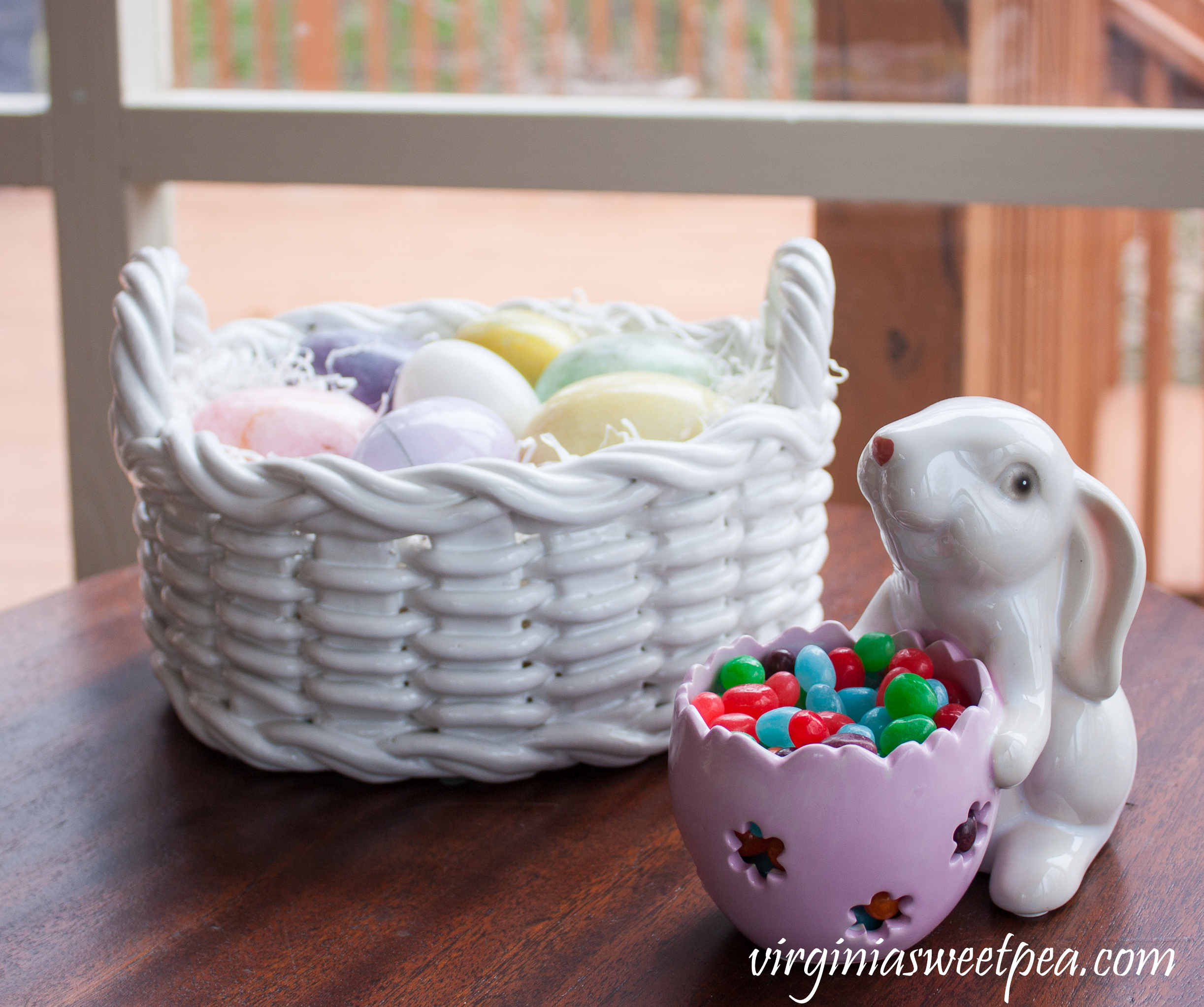 Easter Vignette with a bunny serving jellybeans and a ceramic basket filled with marble eggs