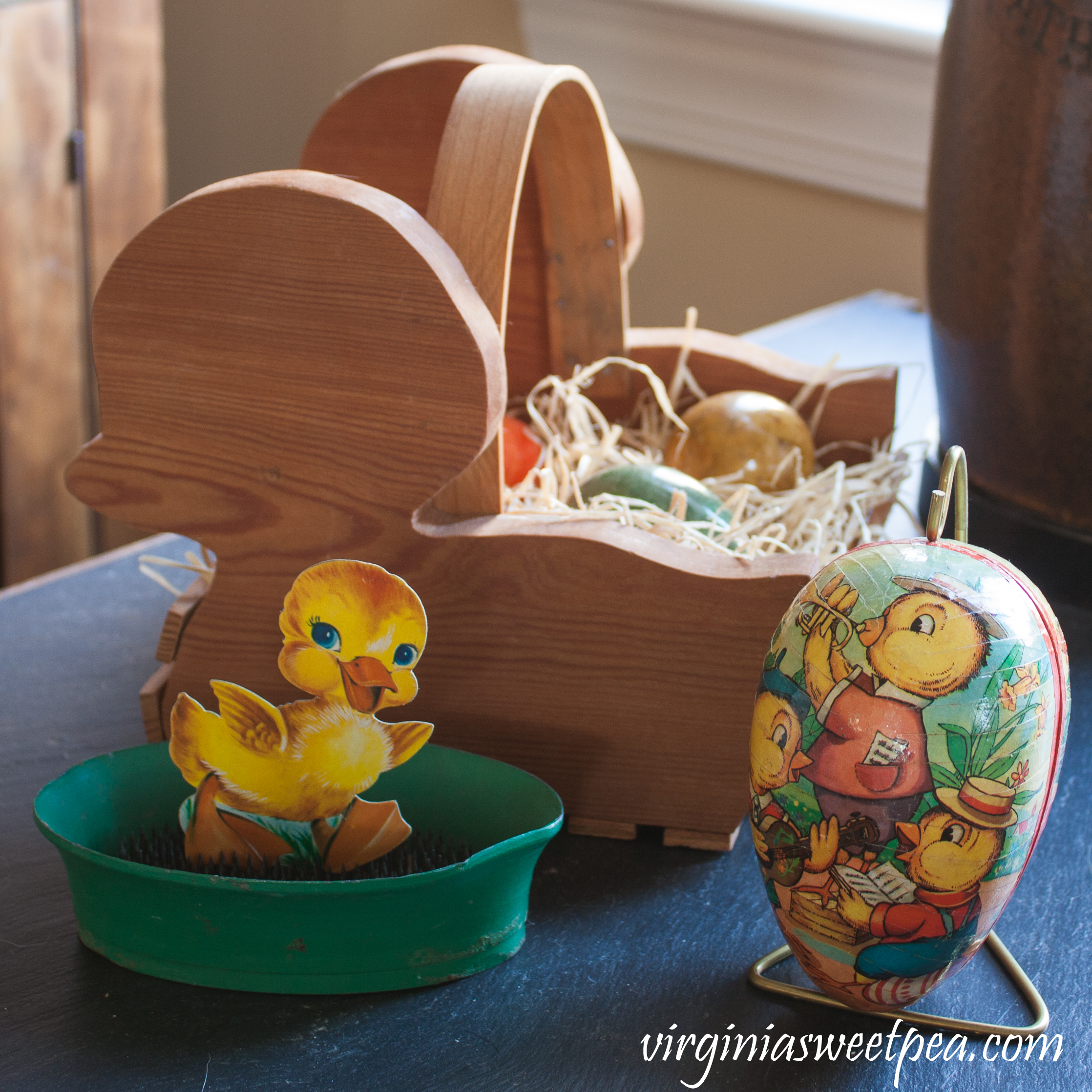 Vintage Easter Decorations - Handmade wooden chick basket from the 1980's filled with marble eggs, a German paper egg from the 1970's, and a vintage duck card displayed using a floral frog