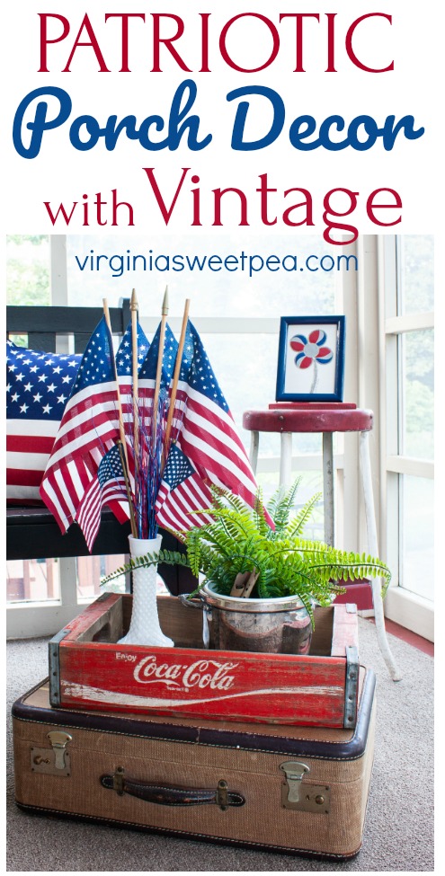 Patriotic display on a porch featuring vintage and red, white, and blue