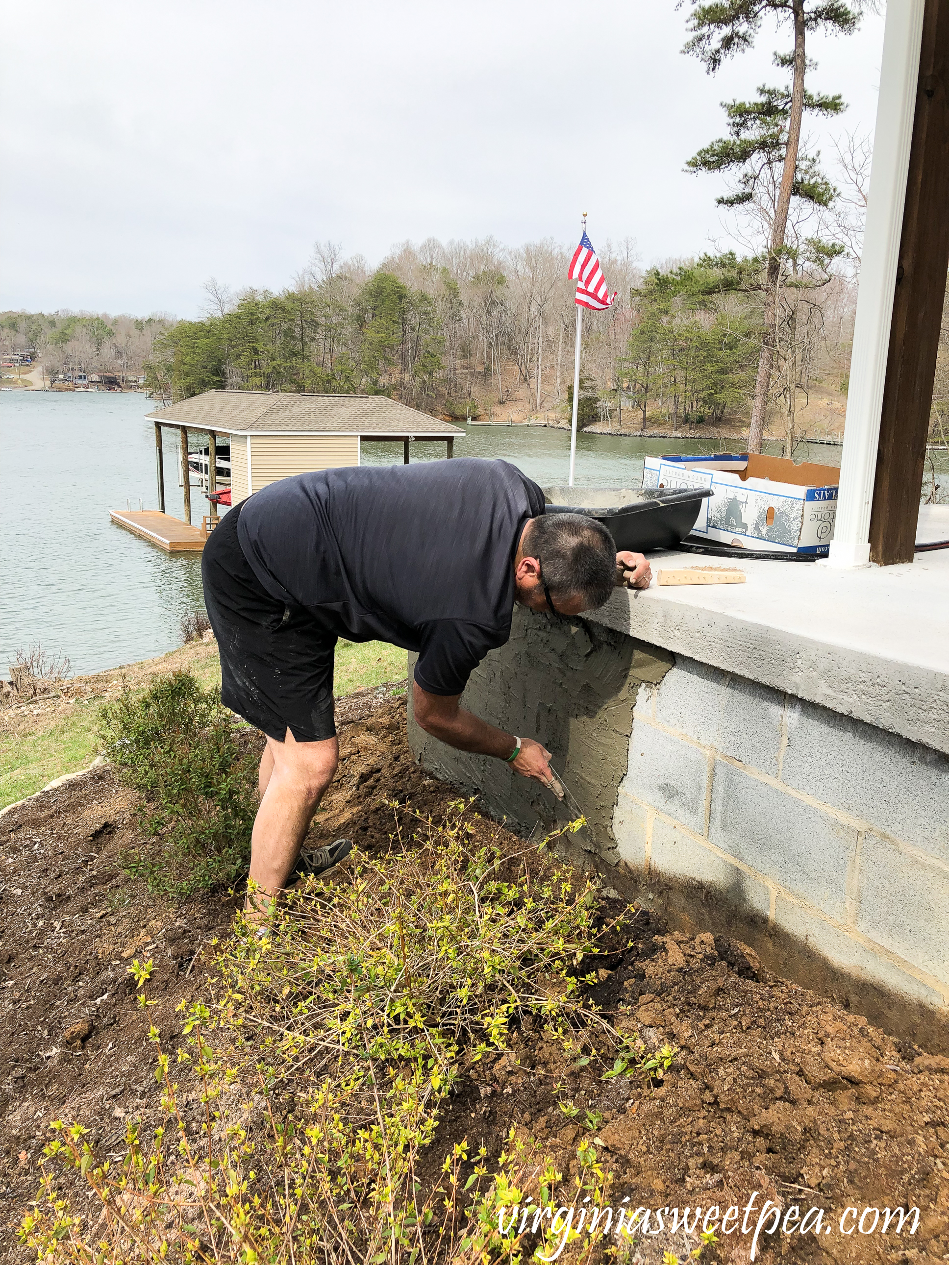 Adding a skim coat of concrete to a patio wall.