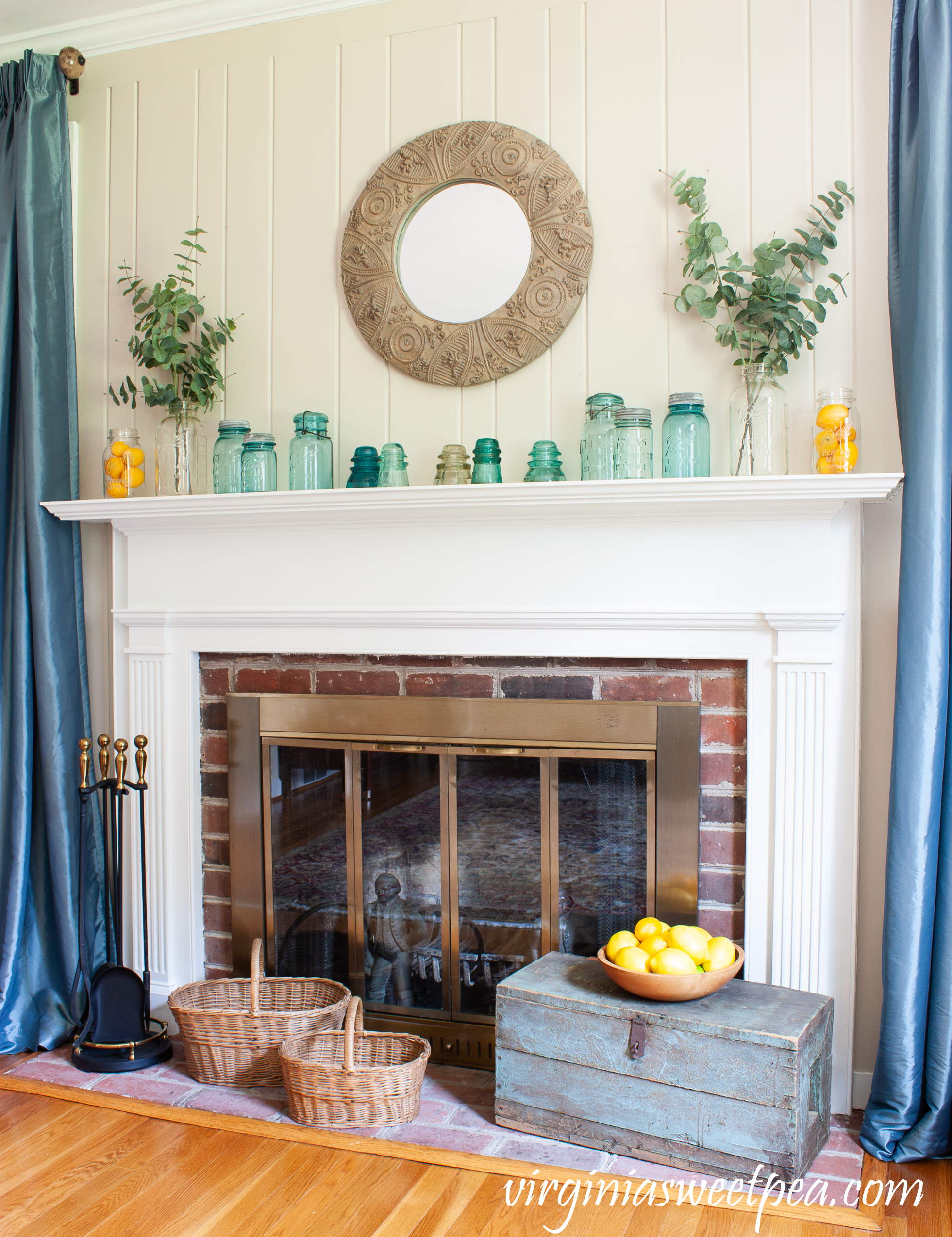 Summer mantel with vintage mason jars, lemons, and eucalyptus. 