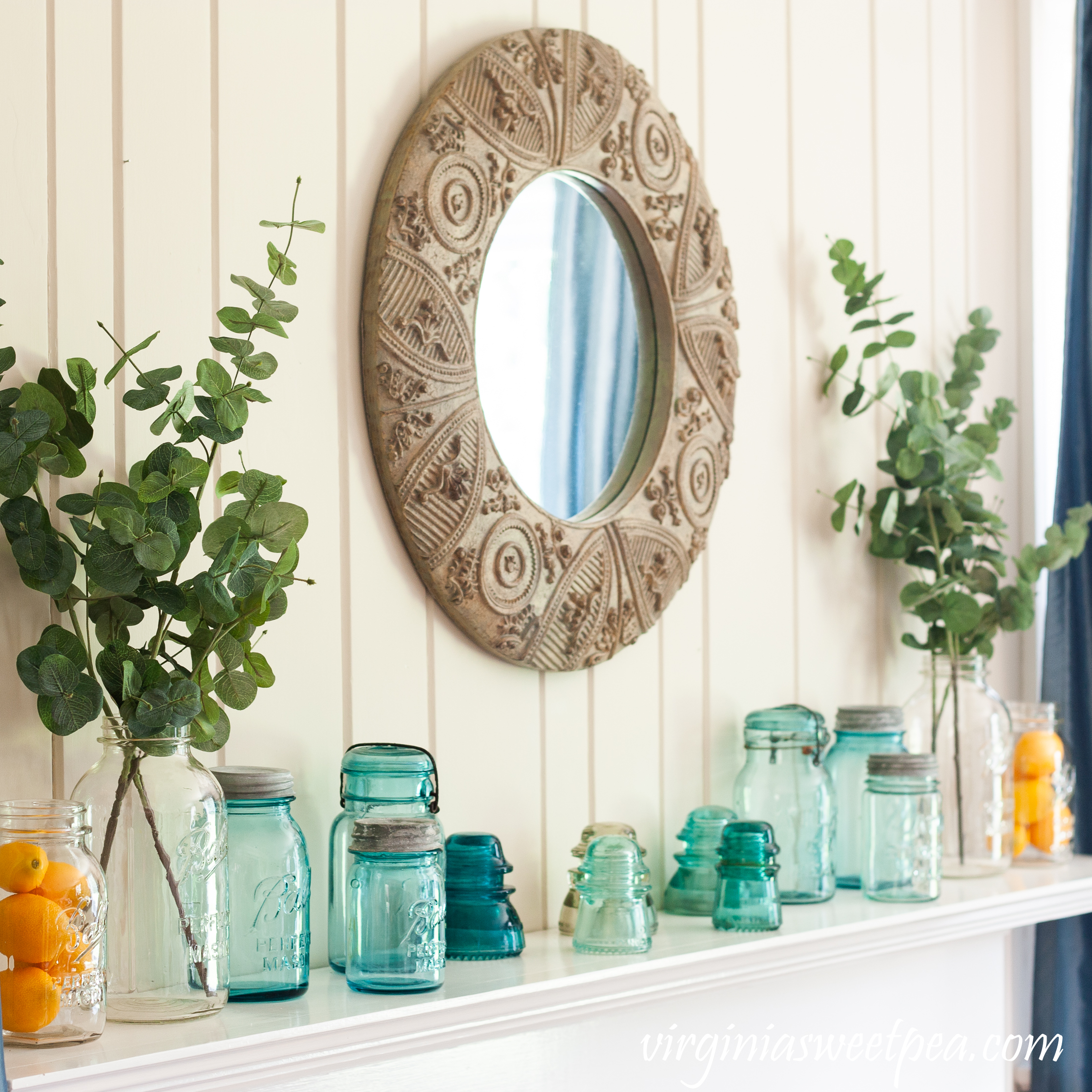 Summer Mantel Decorated with Blue and clear glass Ball Jars, insulators, and lemons.