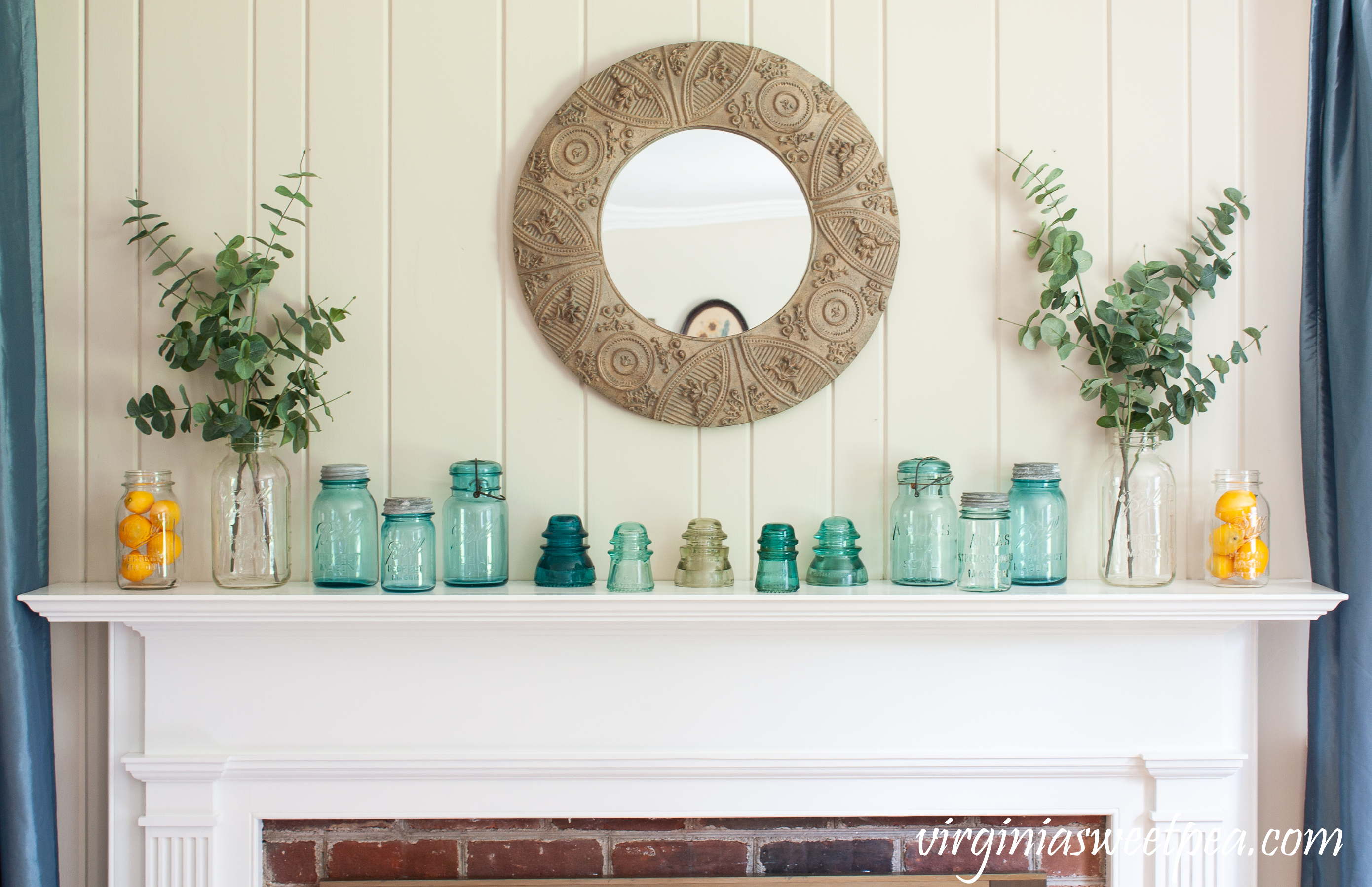 Summer Mantel Decorated with Blue and clear glass Ball Jars, insulators, and lemons.