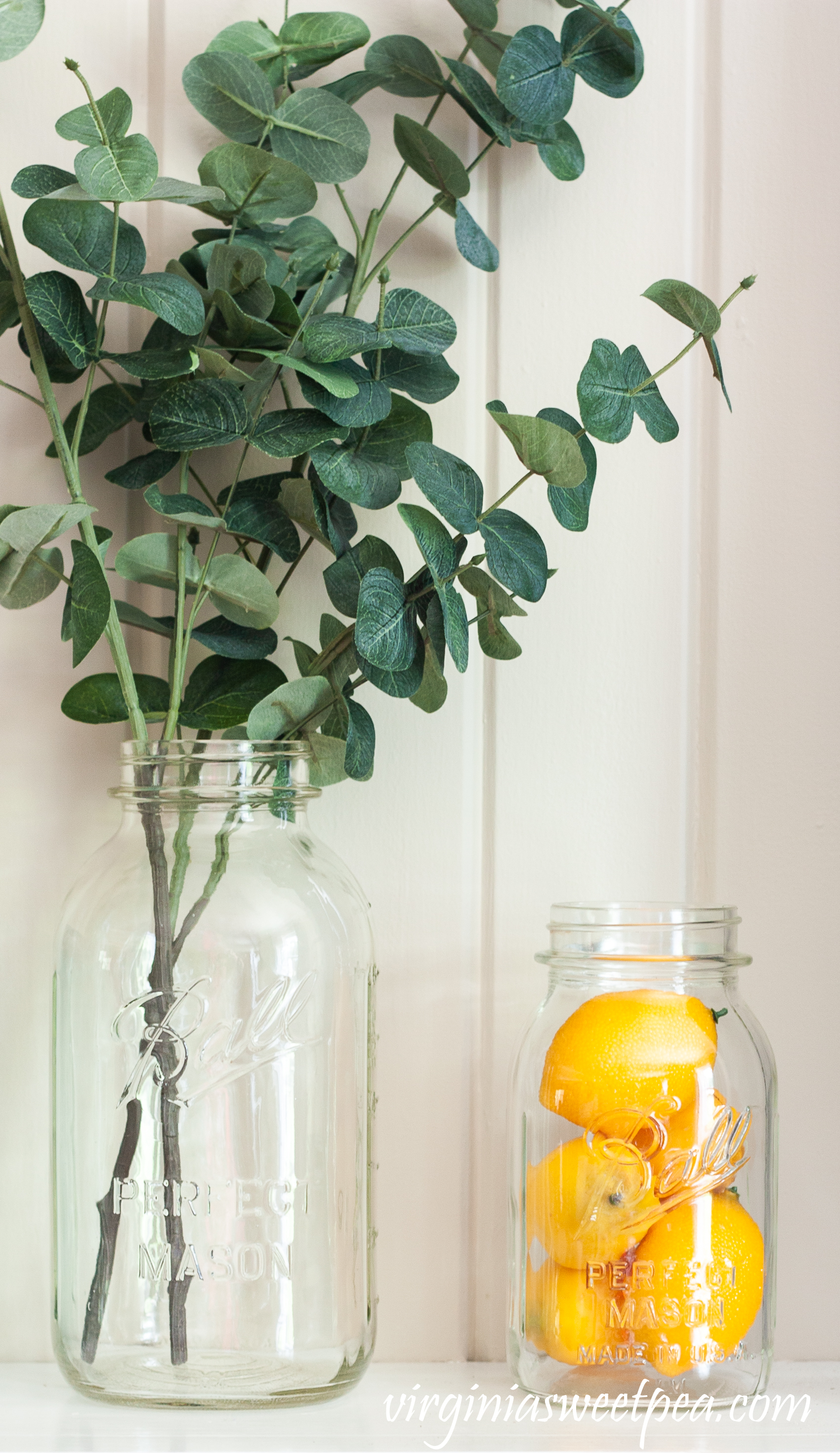 Summer mantel with Ball jars, lemons, and eucalyptus. 