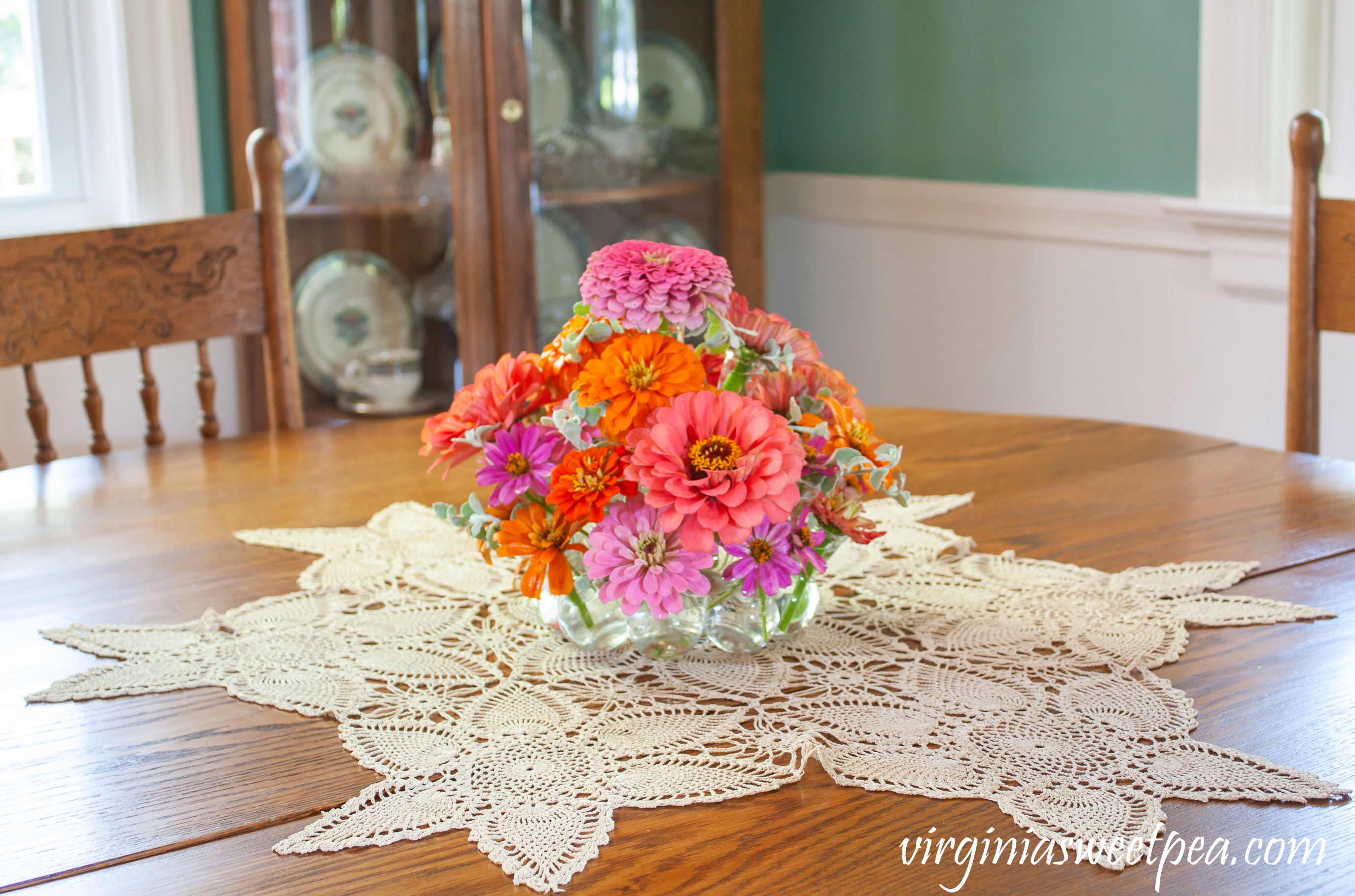 Summer flower arrangement with Zinnias on a dining room table.