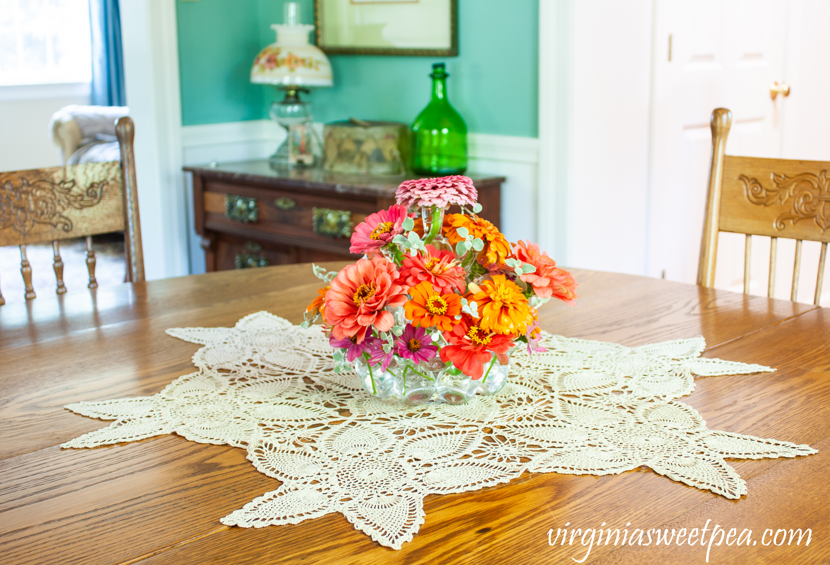 Summer flower arrangement with Zinnias on a dining room table.