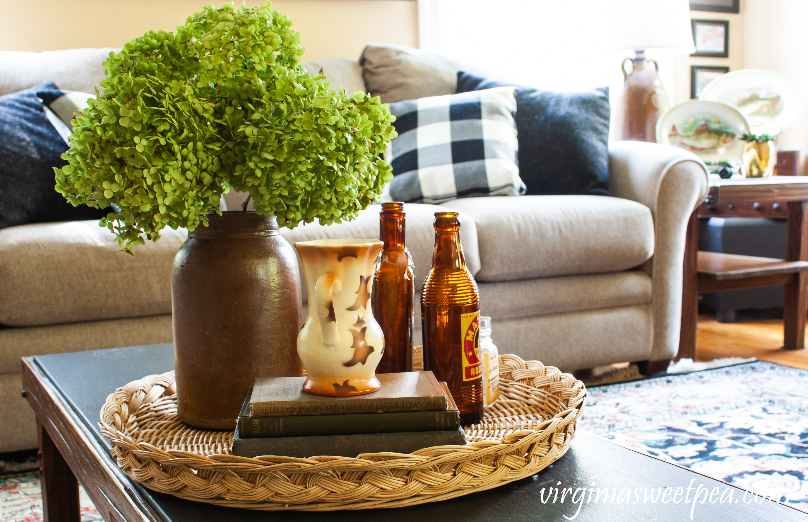 Early Fall coffee table vignette with Hydrangea in an antique crock, vintage bottles and books, and a vintage Czechoslovakian vase.