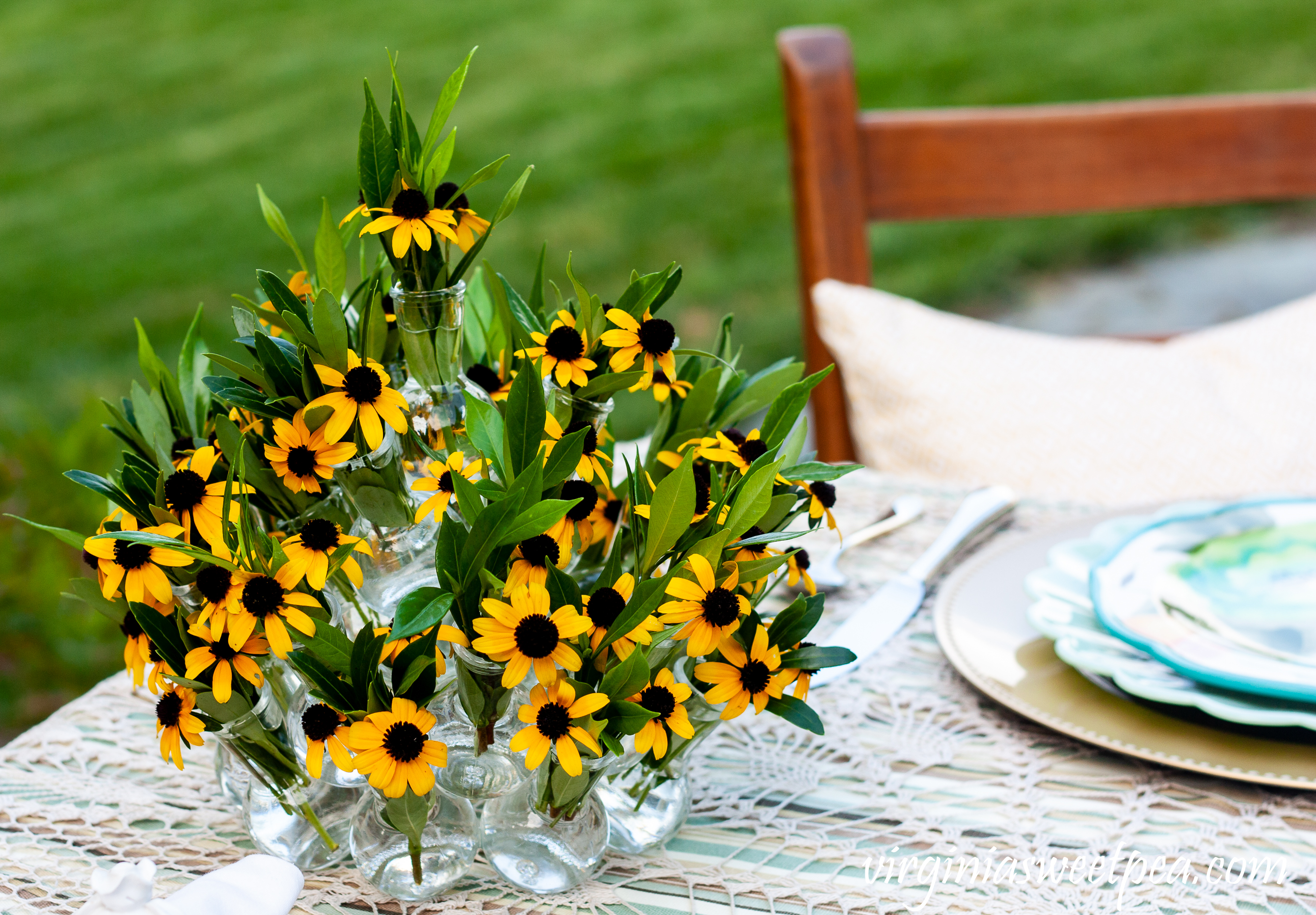 Summer table centerpiece with Rudbeckia and Gardenia foliage