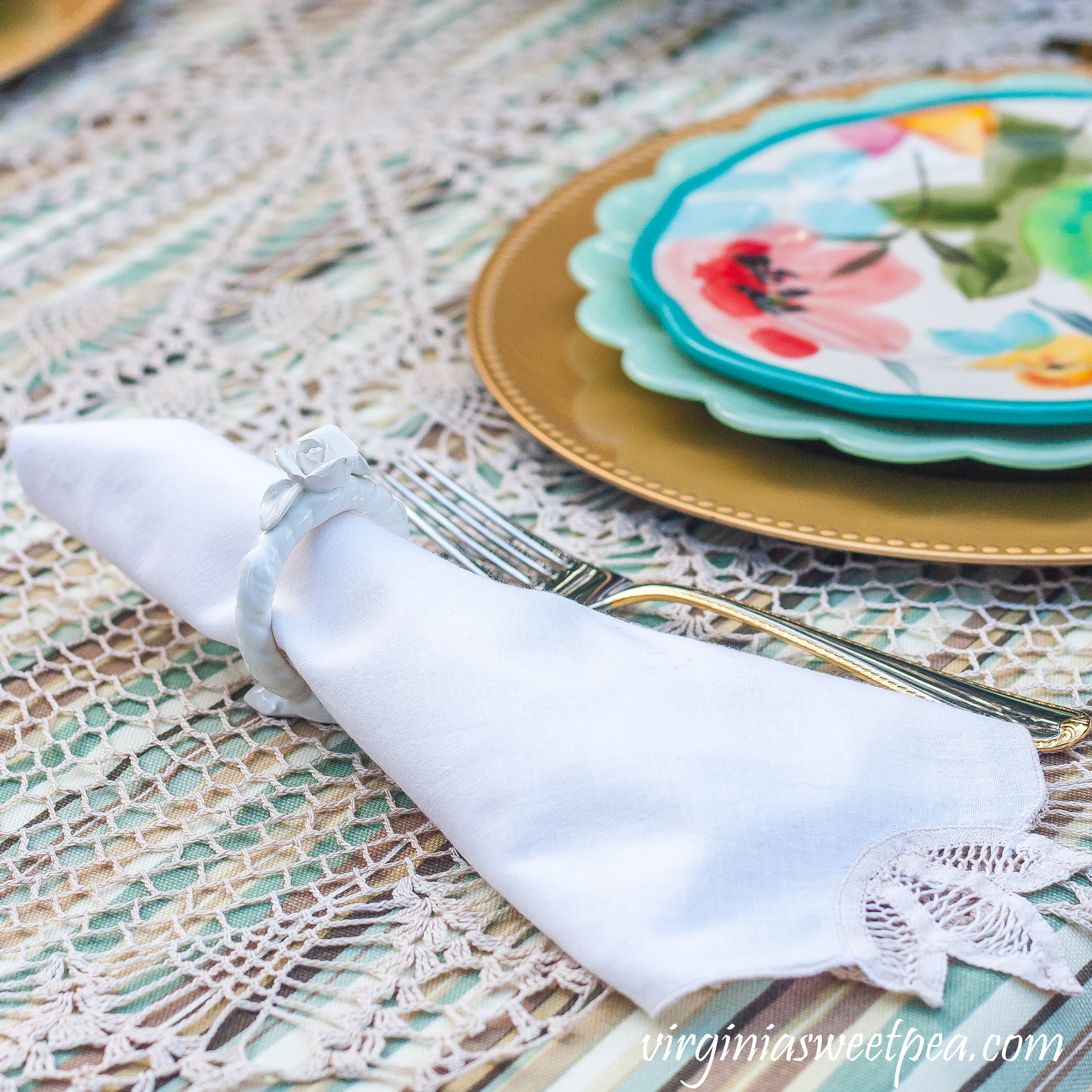 Napkin with cut lace in a floral napkin ring