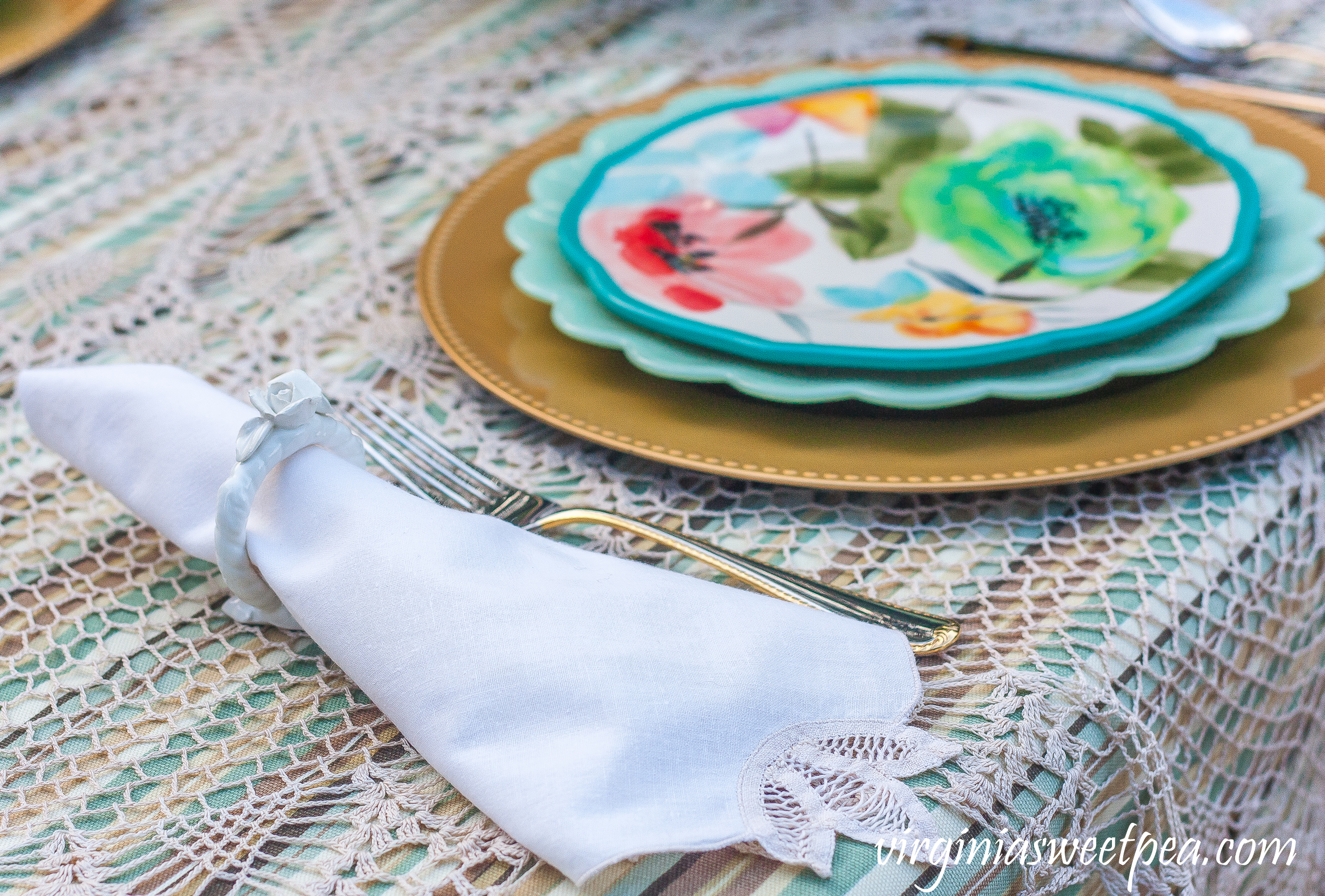 Table setting with Pioneer Woman dishes and Gorham Golden Ribbon Edge flatware.