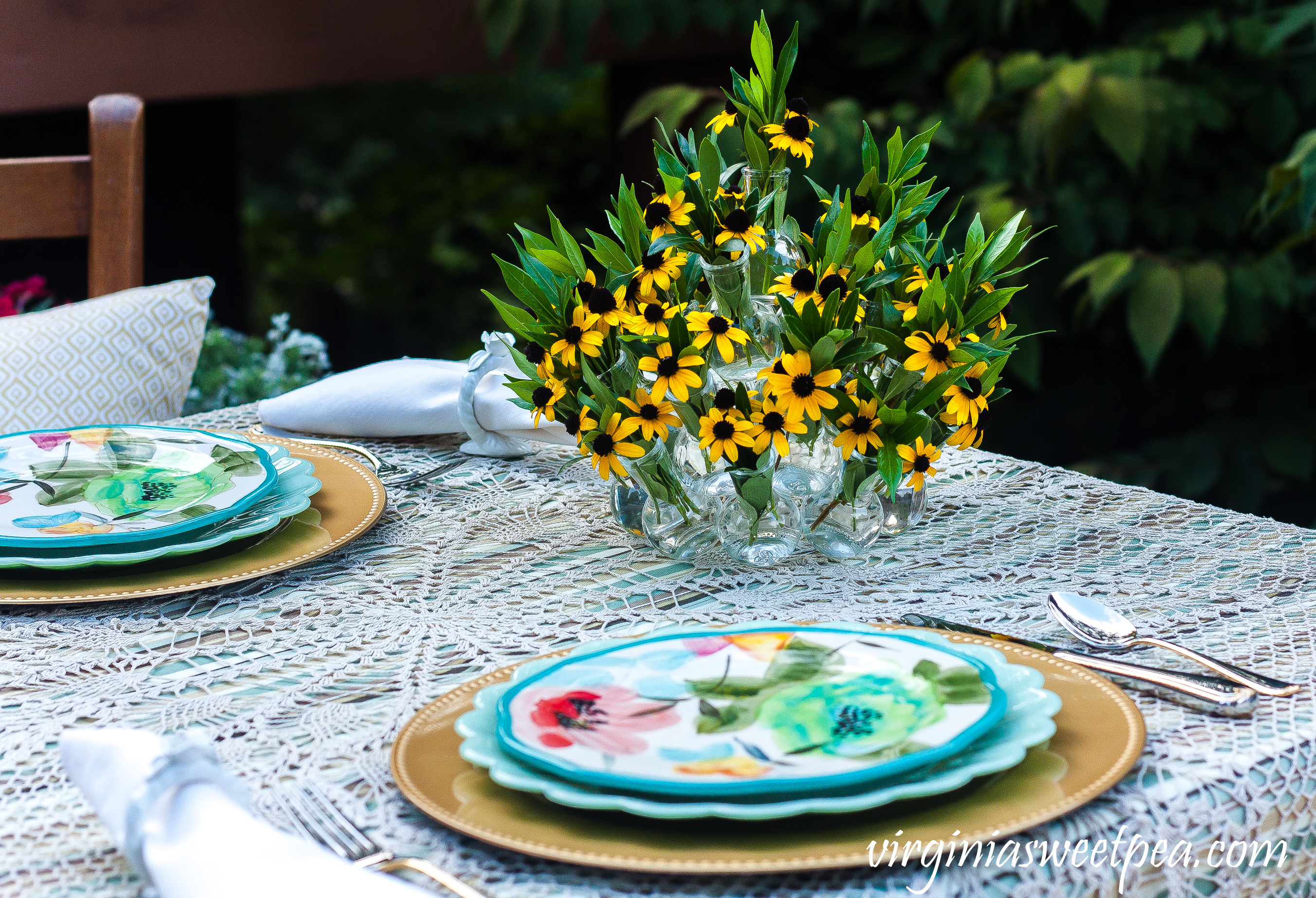 End of summer tablescape set outdoors with Pioneer Woman dishes and a Rudbeckia and Gardenia foliage centerpiece