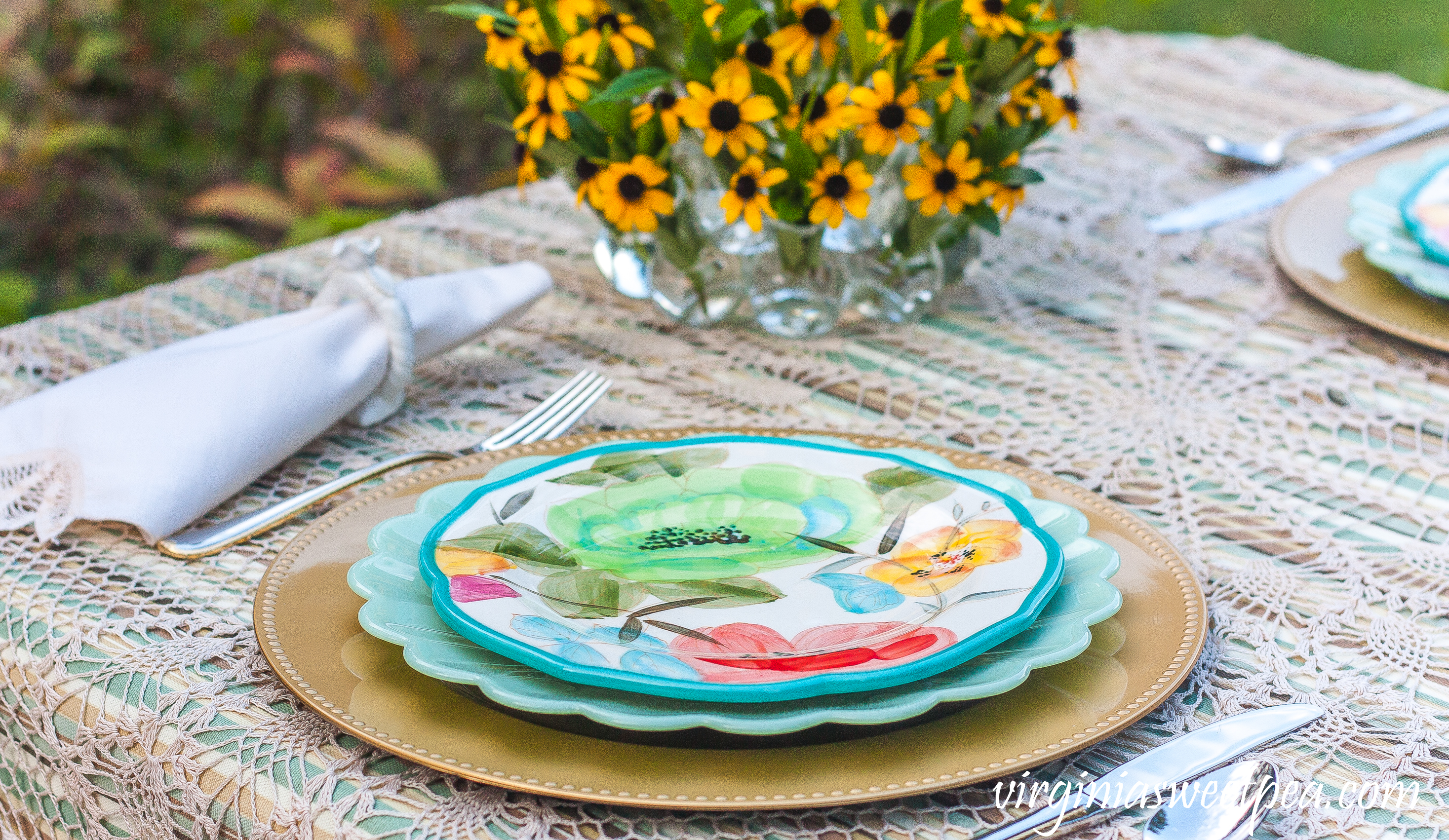 Table setting with Pioneer Woman dishes and Gorham Golden Ribbon Edge flatware.