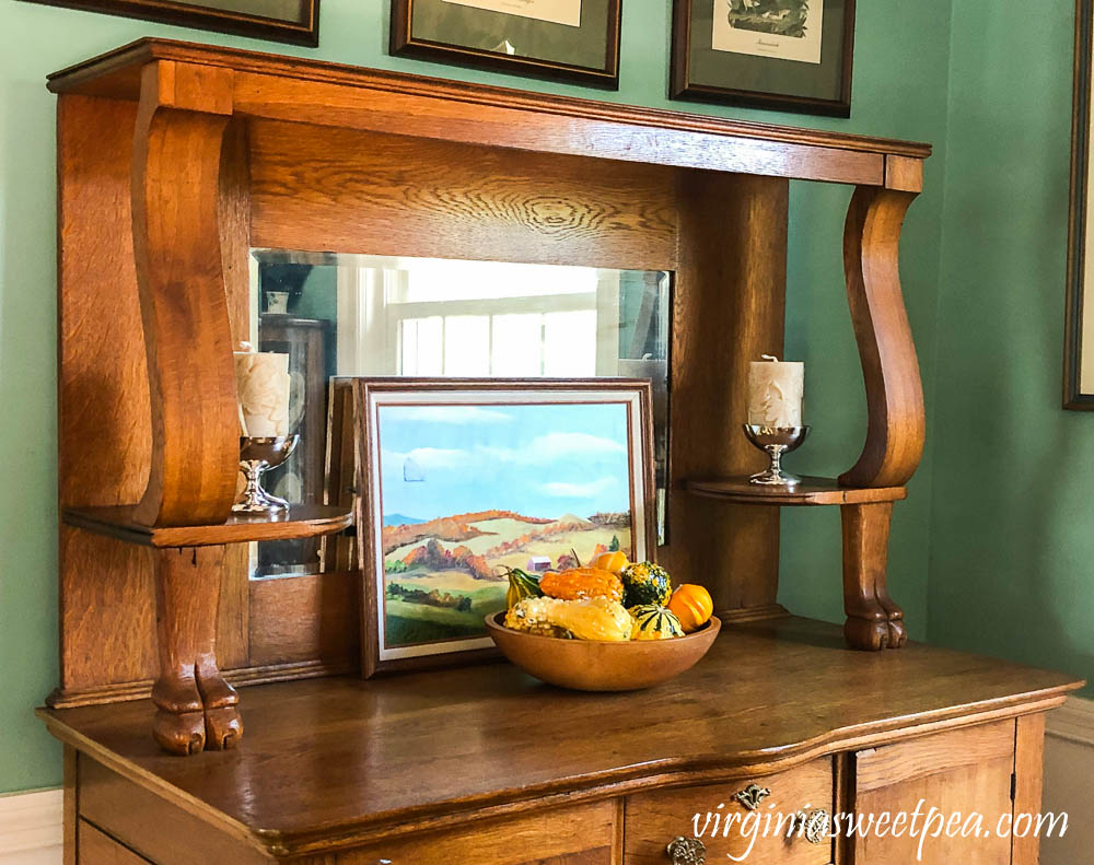 An antique oak buffet decorated for fall