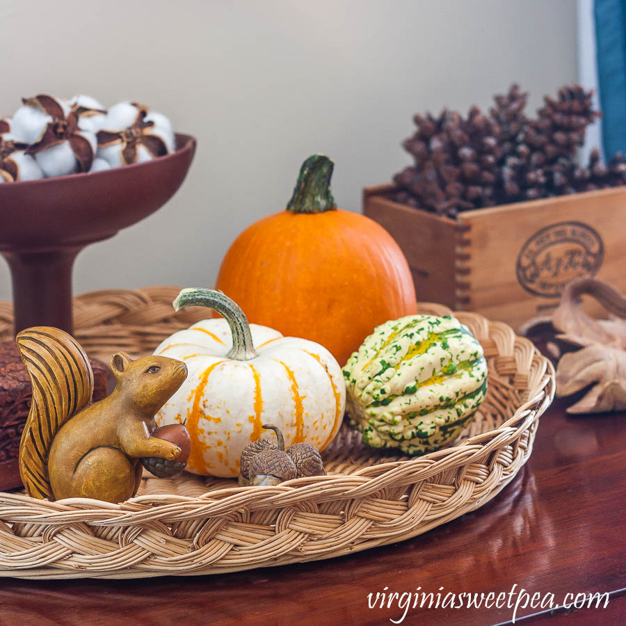 Fall vignette with pumpkins, handmade clay leaves and acorns, cotton bolls in a Hagar compote, and pinecones in a cigar box.