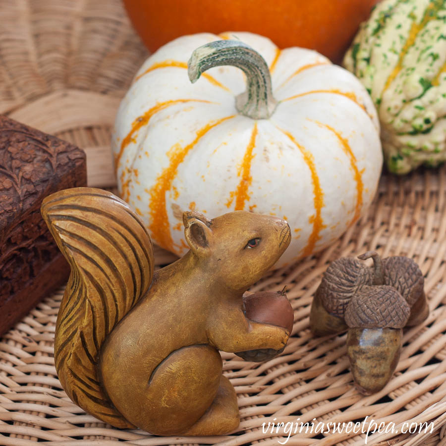 Wood squirrel, handmade clay acorns and a baby pumpkin used in a fall vignette