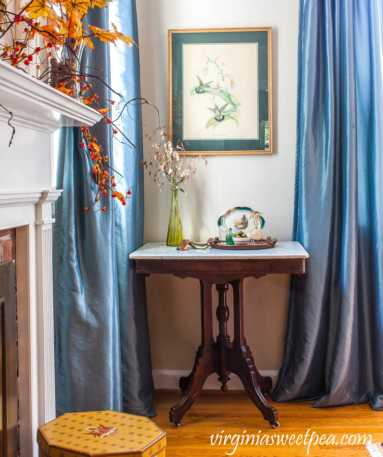 A formal living room decorated for fall with vintage