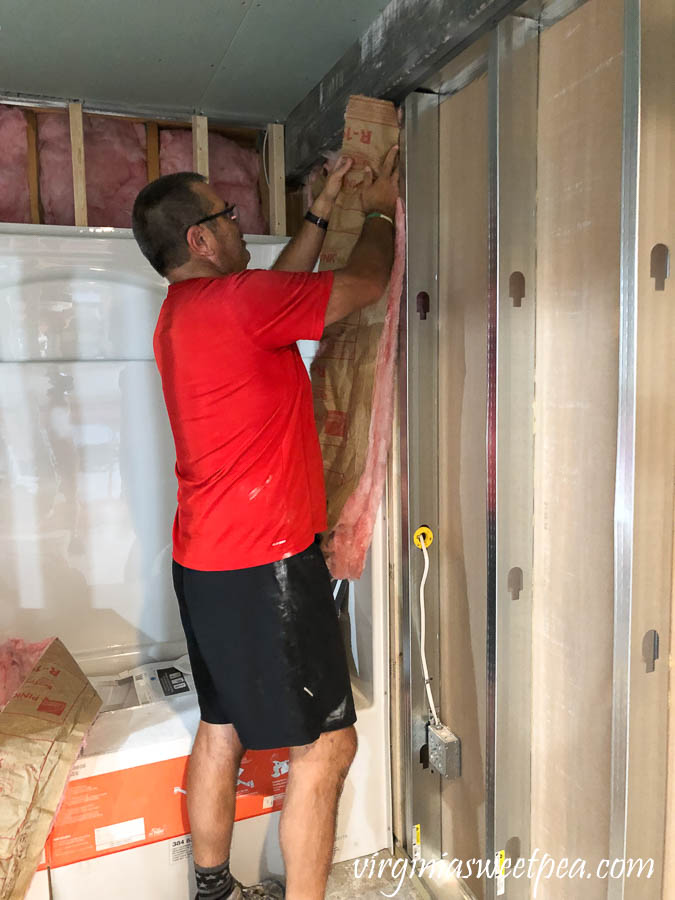 Adding insulation to the basement bathroom.