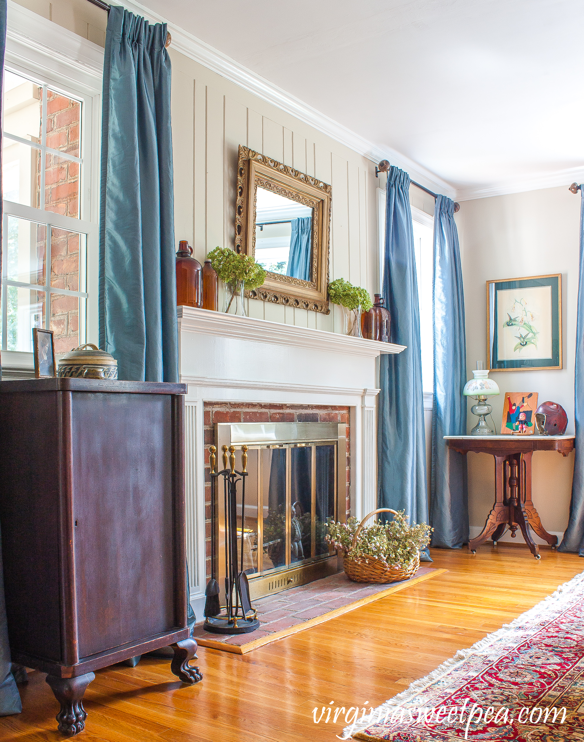 Mantel decorated for early fall with Hydrangea and brown glass bottles.