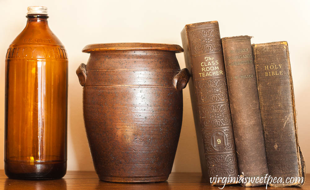 Fleecy White amber Clorox bottle, pottery jar from NC, 1929 The Classroom Teacher, 1918 Inorganic Chemistry book, and a late 1940's Holy Bible.