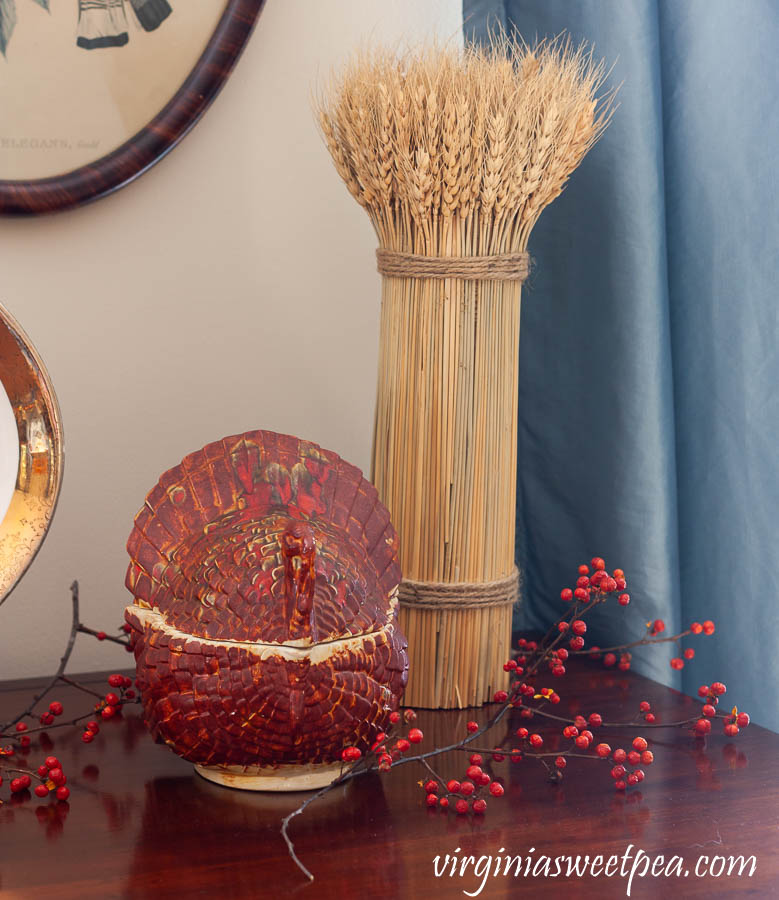 Thanksgiving vignette with a vintage turkey candy dish , a wheat sheaf, and Bittersweet.