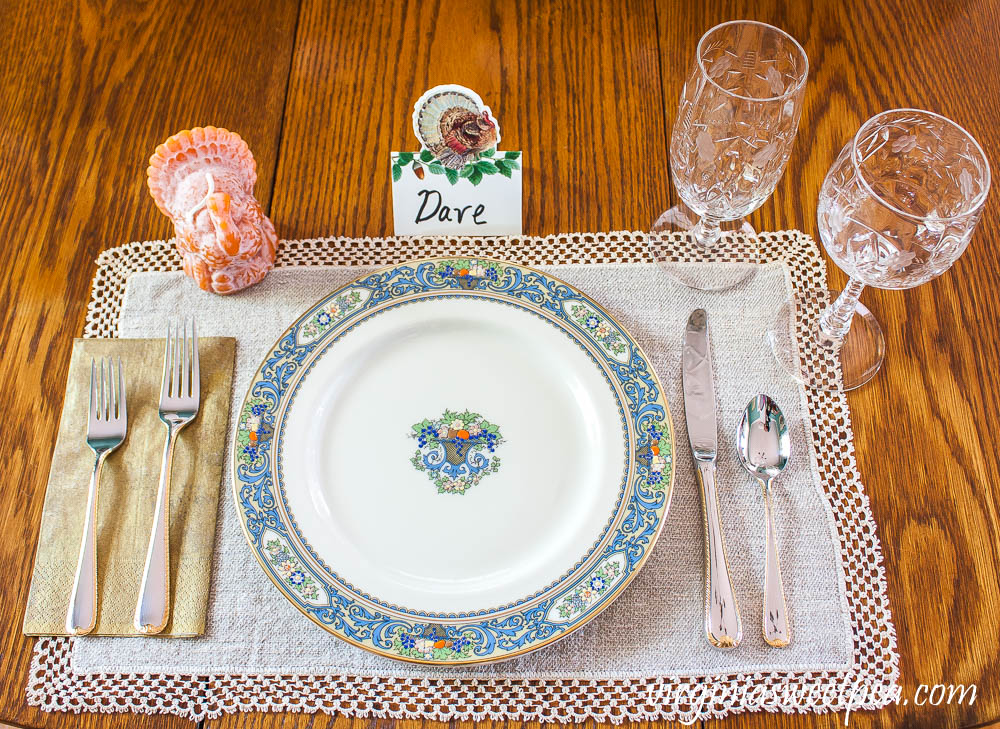 Thanksgiving Place setting with vintage turkeys, a Caspari turkey place card, beeswax turkey candle, Lenox Autumn dishes, vintage Rock Sharp crystal, and Gorham Golden Ribbon Edge Silverware.
