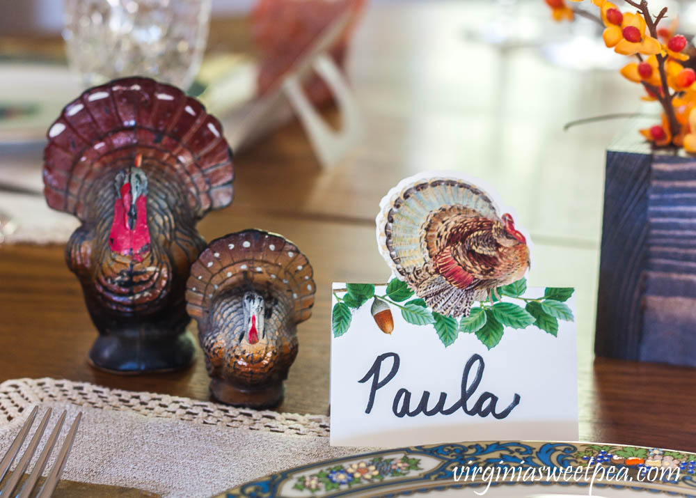 Thanksgiving place setting with a Caspari turkey place card and vintage turkey candles.