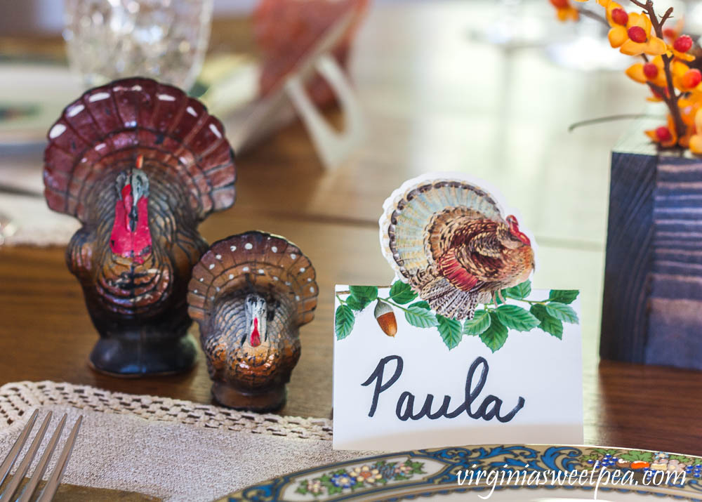 Thanksgiving place setting with a Caspari turkey place card and vintage turkey candles.