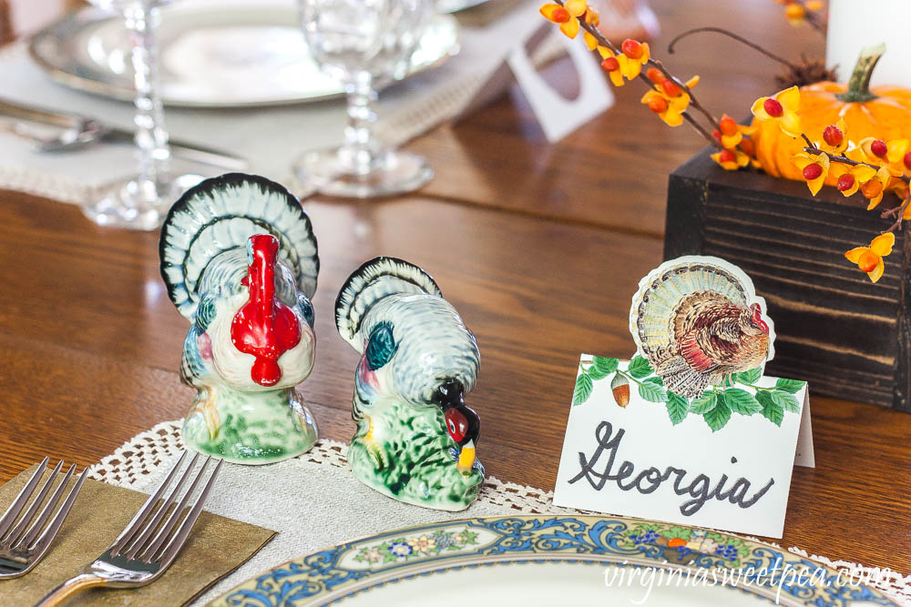 Thanksgiving table with a Caspari turkey place card and vintage turkey salt and pepper shakers