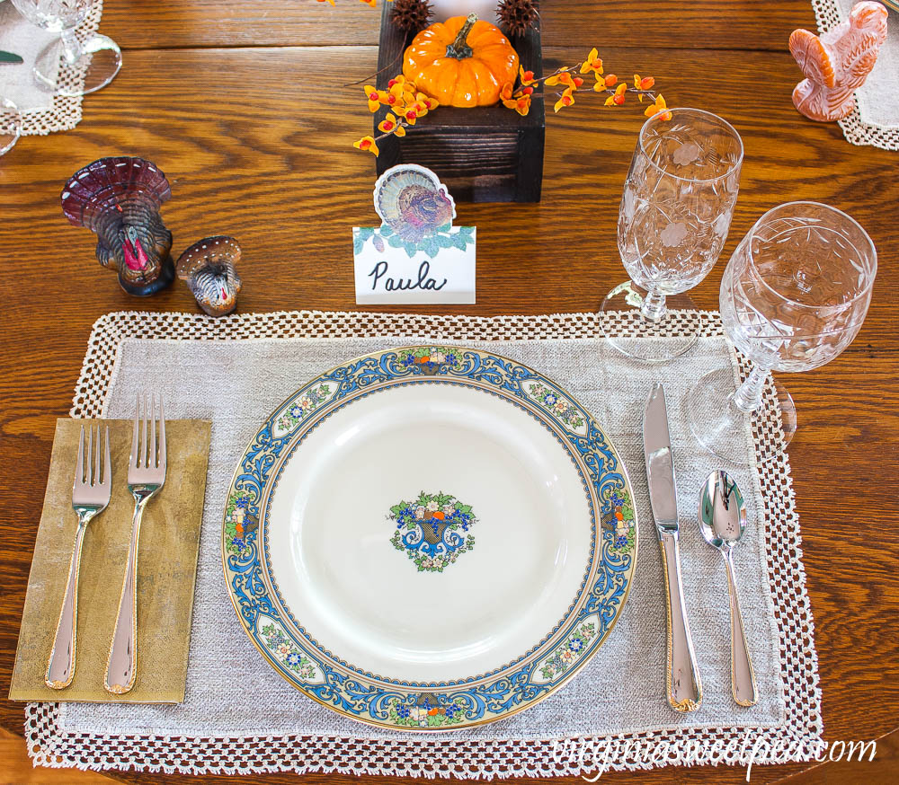 Thanksgiving Place setting with vintage turkeys, a Caspari turkey place card, vintage turkey candles, Lenox Autumn dishes, vintage Rock Sharp crystal, and Gorham Golden Ribbon Edge Silverware.