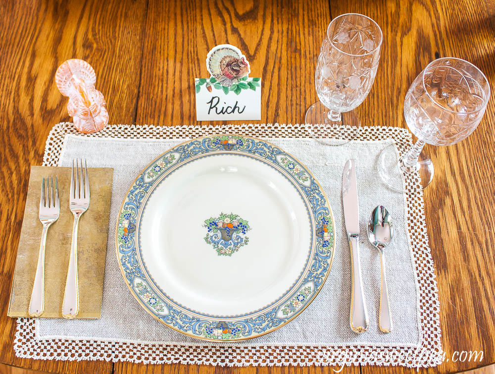 Thanksgiving Place setting with vintage turkeys, a Caspari turkey place card, beeswax turkey candle, Lenox Autumn dishes, vintage Rock Sharp crystal, and Gorham Golden Ribbon Edge Silverware.