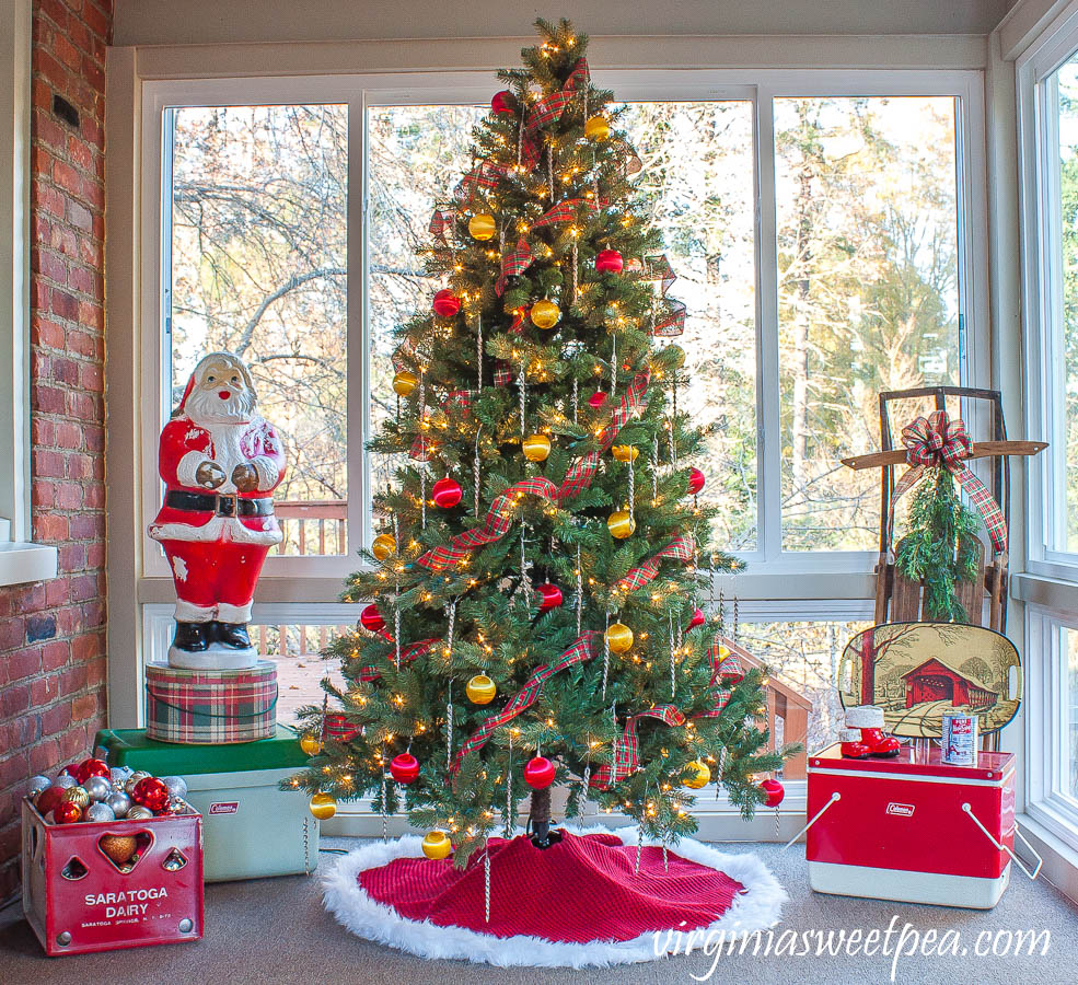 A Very Vintage Christmas on the Porch - An enclosed porch is decorated for Christmas with a vintage Santa blow mold, vintage coolers, a vintage sled, and more.