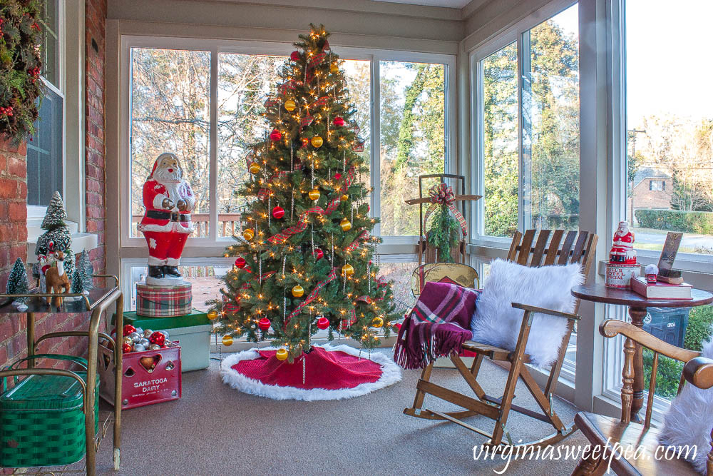 A Very Vintage Christmas on the Porch - An enclosed porch is decorated for Christmas with a vintage Santa blow mold, vintage coolers, a vintage sled, and more.