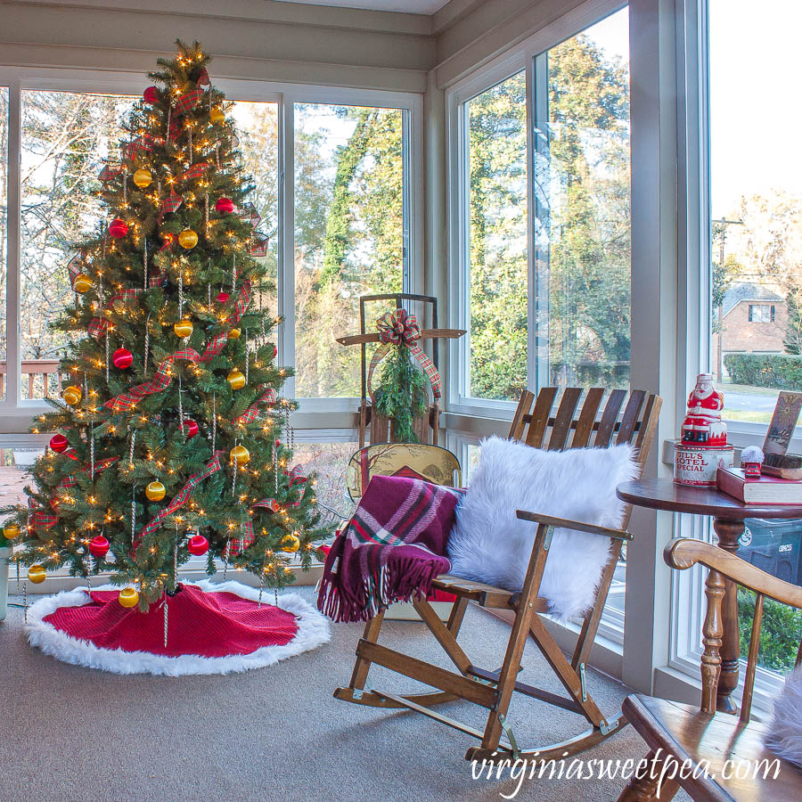 A Very Vintage Christmas on the Porch - An enclosed porch is decorated for Christmas with a vintage Santa blow mold, vintage coolers, a vintage sled, and more.