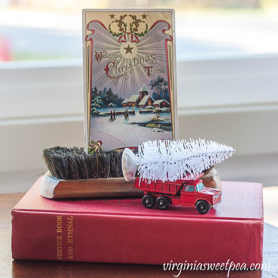 1910 Christmas postcard, vintage shoe brush, vintage Matchbox truck and a 1958 hymnal.