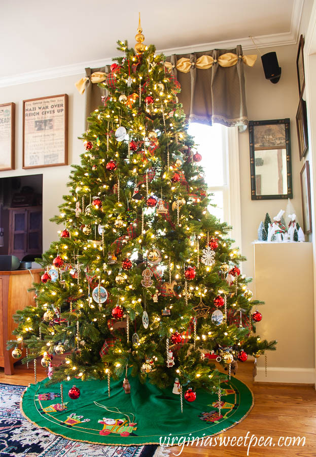 Family room Christmas tree decorated with ornament collected over 25 years.