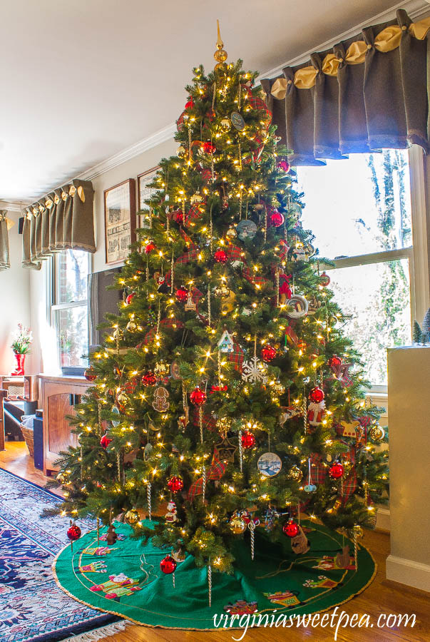 Family room Christmas tree decorated with ornament collected over 25 years.