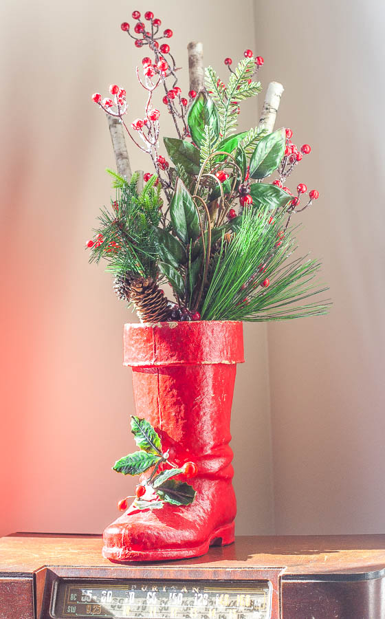 Christmas vignette with an antique Santa boot filled with Christmas greenery