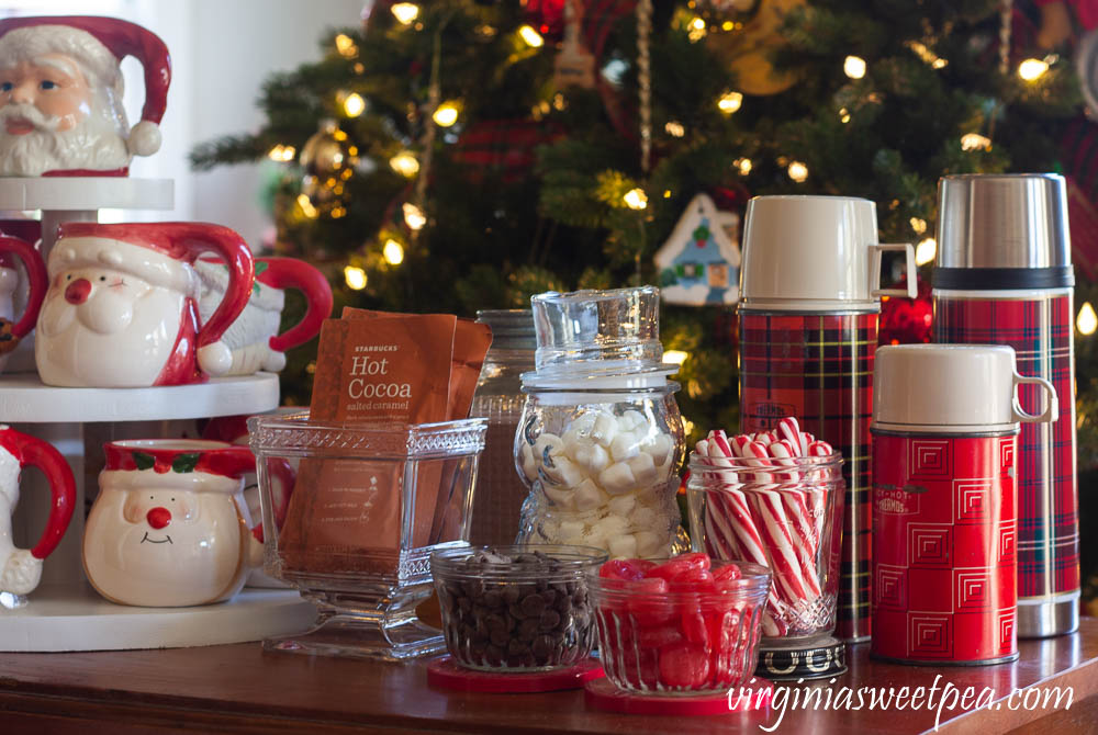 Hot Chocolate Bar with Vintage - Vintage jelly jars holding chocolate chips and cinnamon candy, a Nescafe jar holding peppermint sticks, and a trio thermoses.