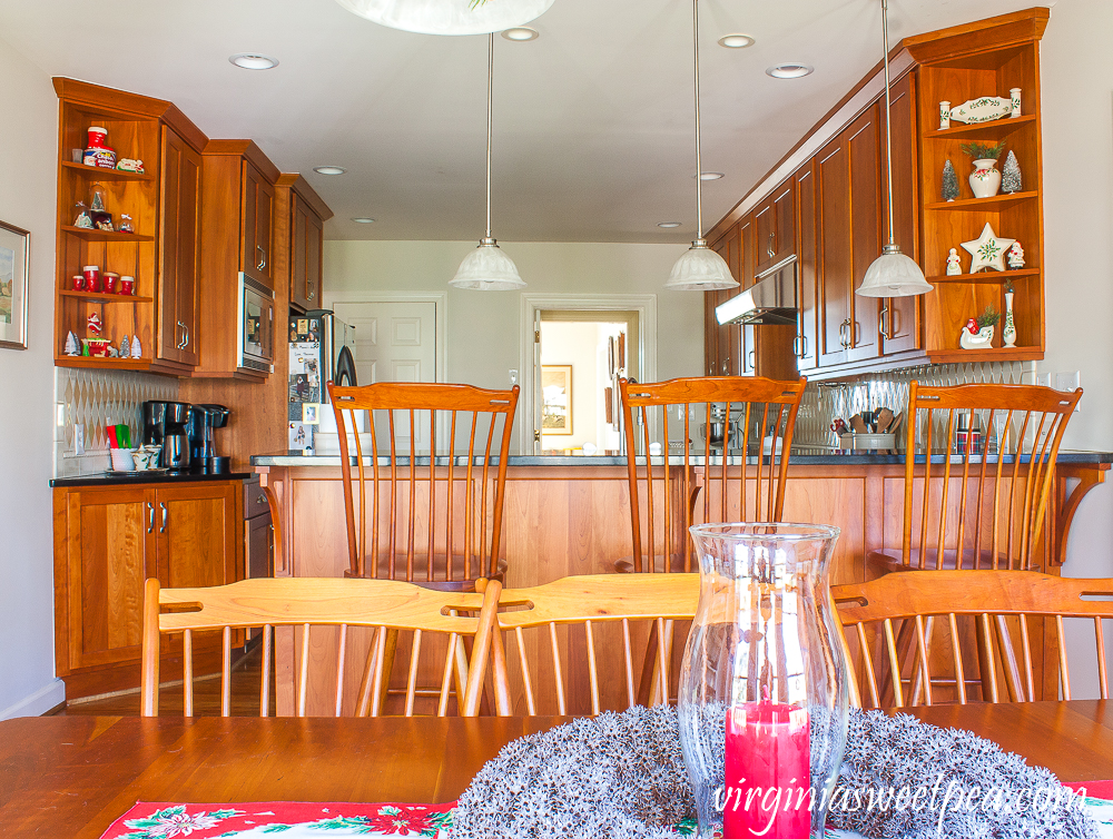 Kitchen with cherry cabinets decorated for Christmas with vintage.