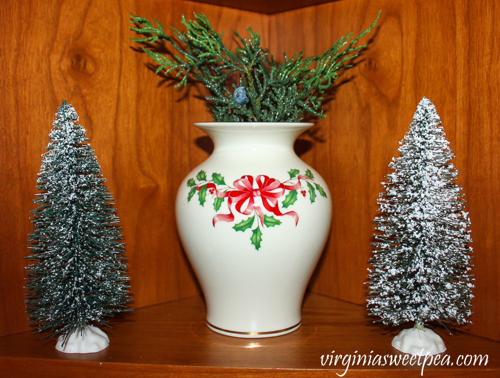 Kitchen shelf decorated for Christmas with Lenox Holiday star and bottlebrush trees