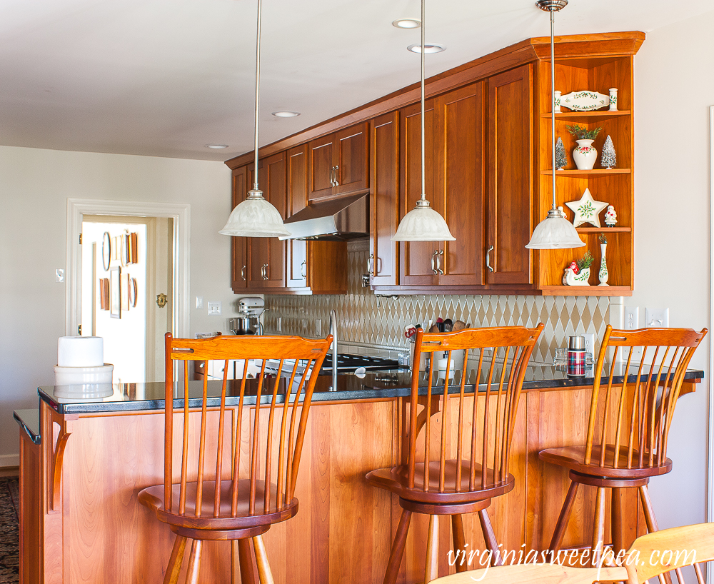 Kitchen with cherry cabinets decorated for Christmas with vintage.