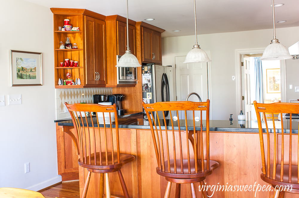 Kitchen with cherry cabinets decorated for Christmas with vintage.