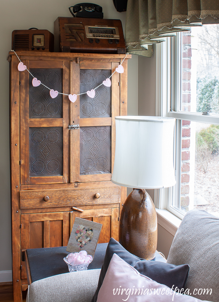 Heart Garland hanging on an antique pie safe