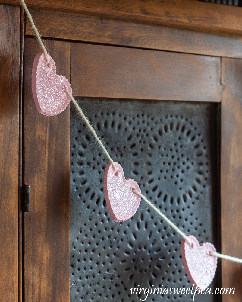 Heart Garland hanging on an antique pie safe