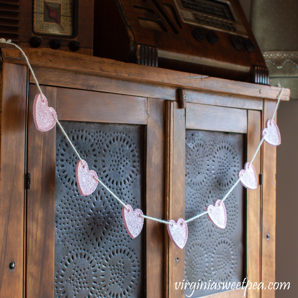 Heart Garland hanging on an antique pie safe