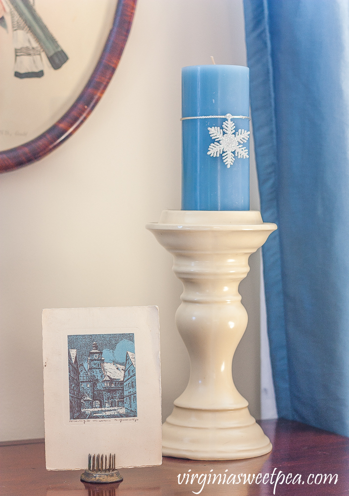 Vintage German Christmas card, cream candle holder with blue candle with a snowflake ornament tied to it.