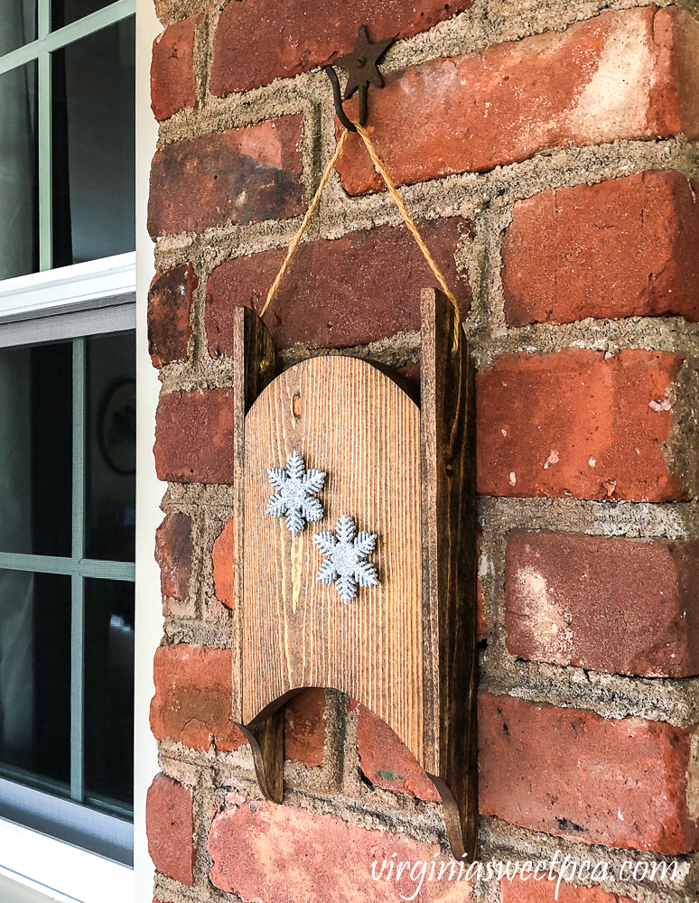 Wood sled made in the 1980s refinished and decorated with snowflakes.