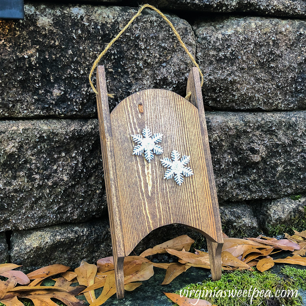 Wood sled made in the 1980s refinished and decorated with snowflakes.